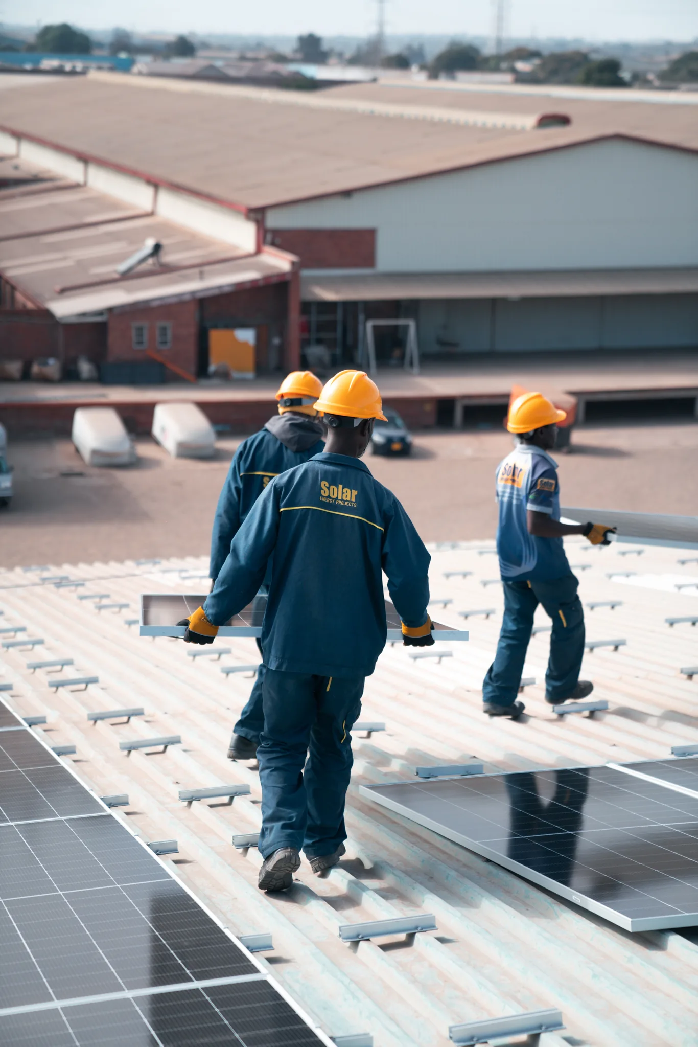 Penhalonga Energy crew installing solar PV on a commercial rooftop